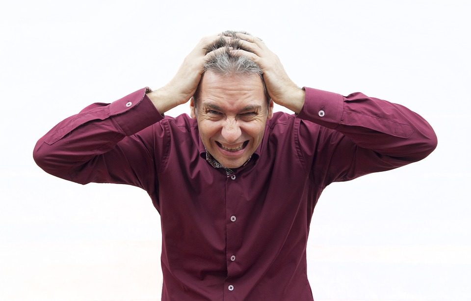 A man pressing his head