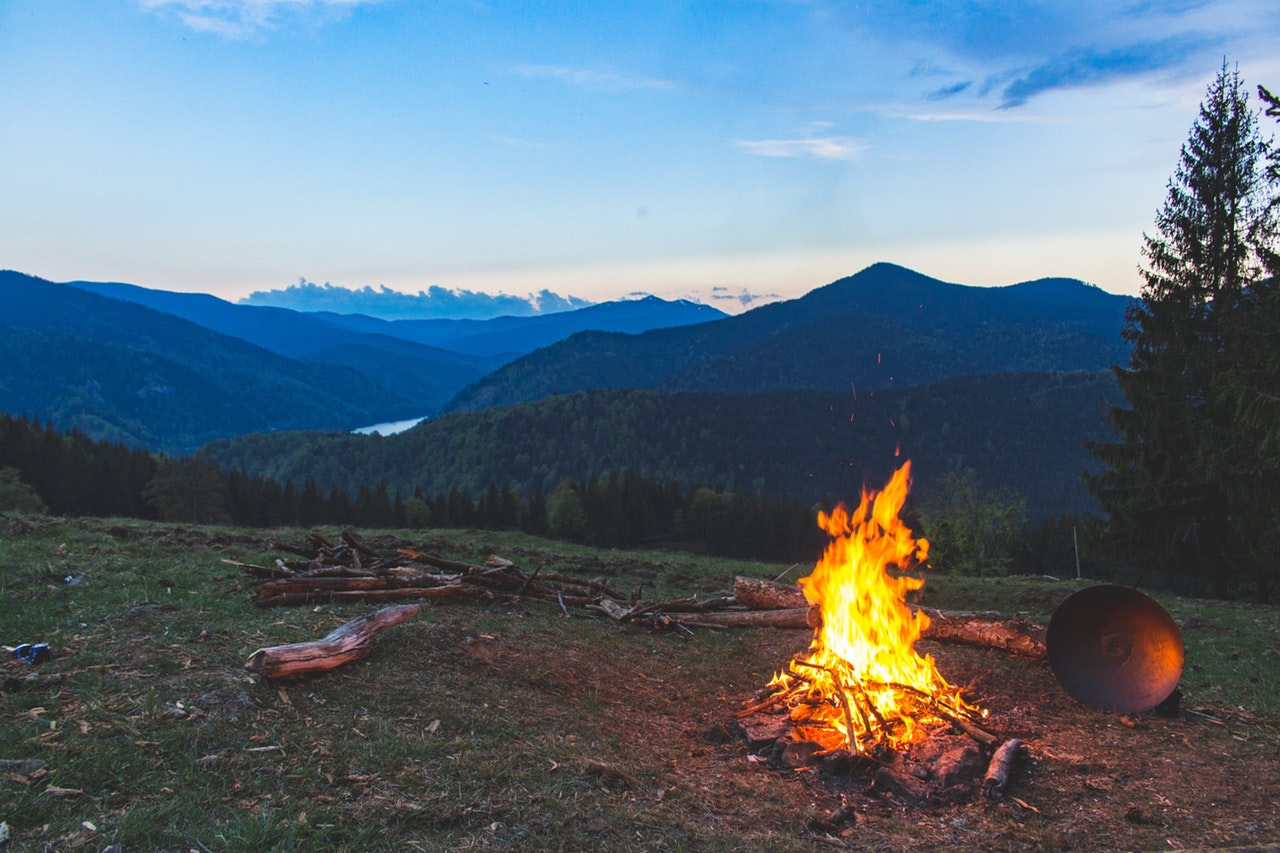 bonfoire surrounded by mountains